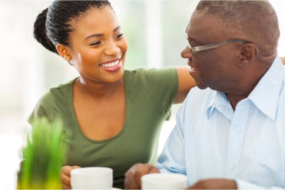 elder man enjoying coffee with his caregiver